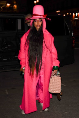 Erykah Badu wearing a long pink Valentino coat and hat