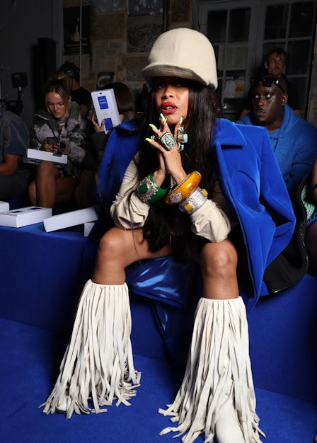 Erykah Badu wearing white boots with long tassels at the spring 2023 Off-White show