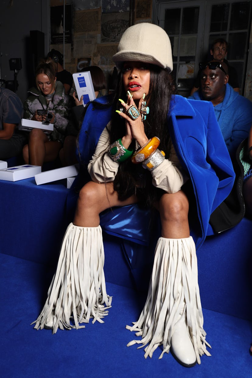 Erykah Badu wearing white boots with long tassels at the spring 2023 Off-White show
