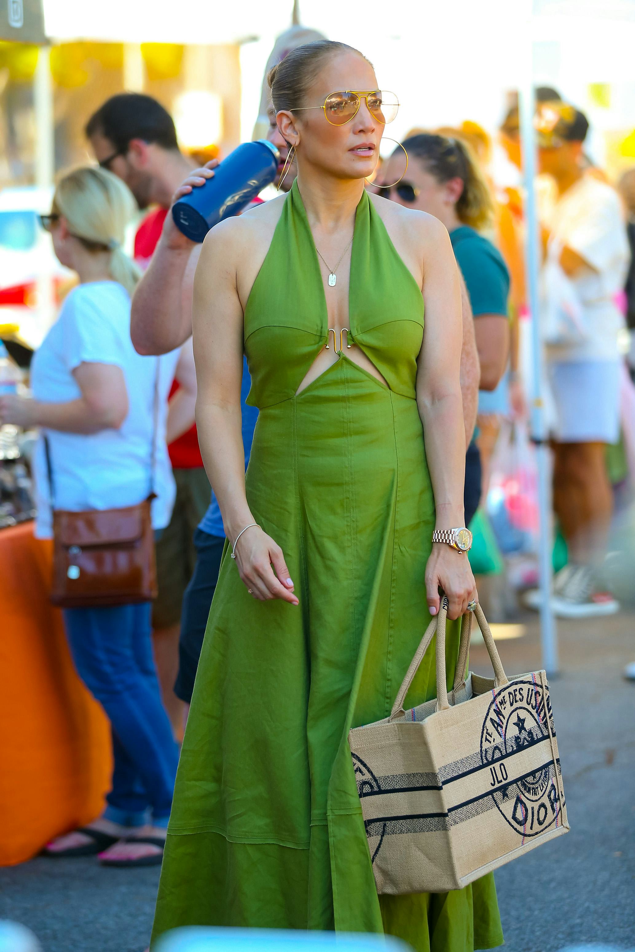 Jennifer Lopez in a green dress while carrying a Dior bag