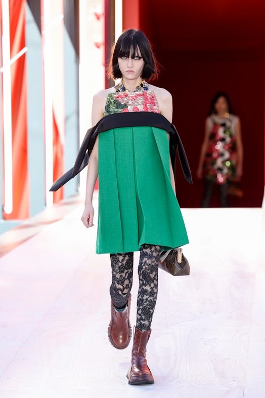A model in a green-black-floral dress with pleats at the Louis Vuitton Spring 2023 Paris Fashion Wee...