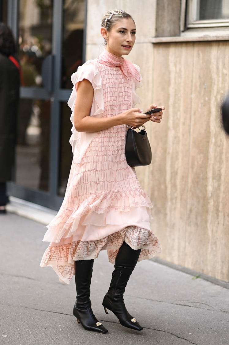 Jenny Walton is seen wearing a pink Lanvin dress, black boots and black and gold Lanvin dress and go...