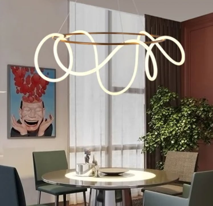 The gold ring chandelier from Wayfair is a cheaper alternative to Emma Chamberlain's modern chandeli...