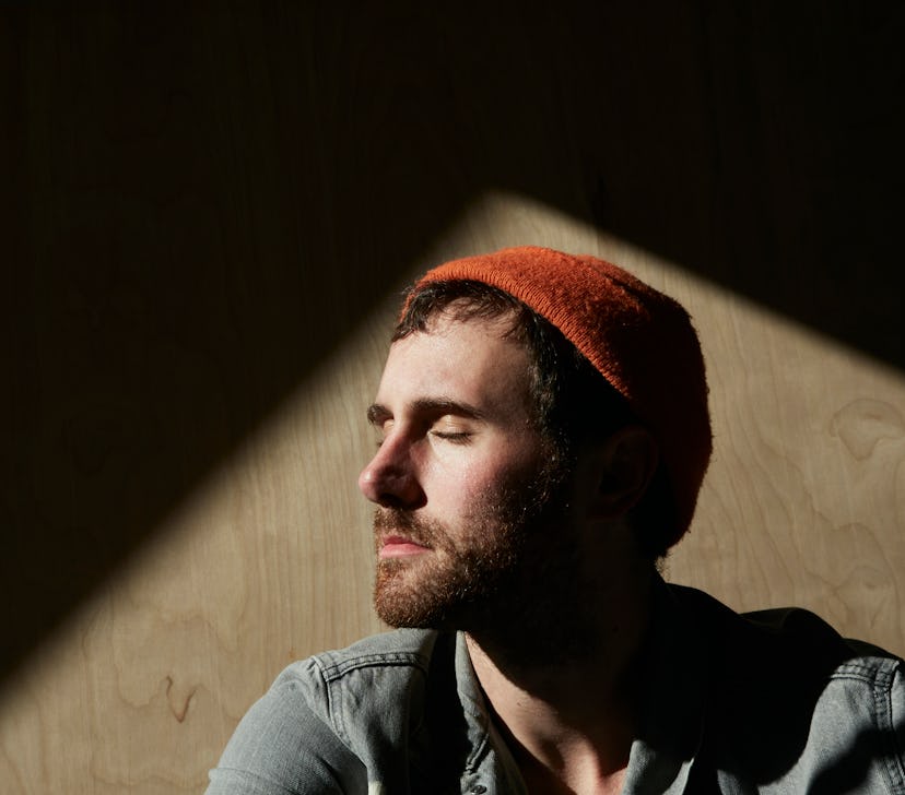 Man in beanie sitting in sunlight 
