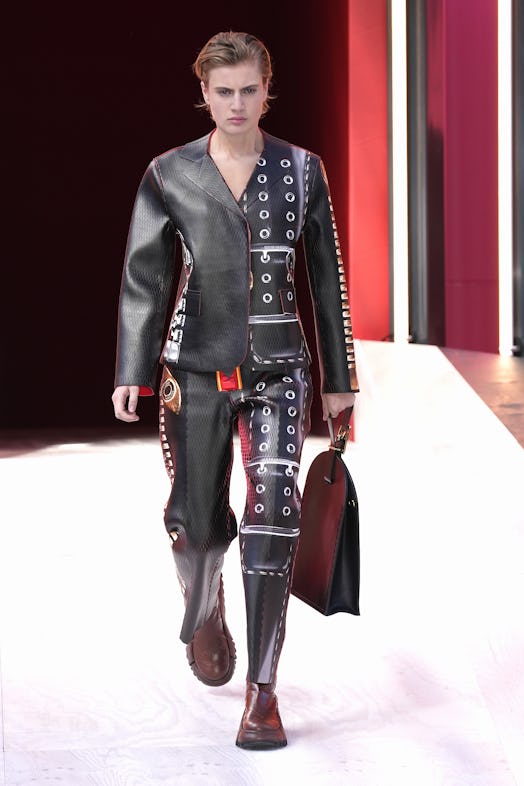 A model in a black leather suit with belt-print at the Louis Vuitton Spring 2023 Paris Fashion Week