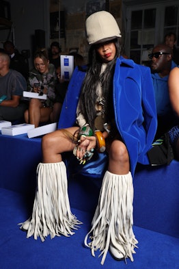 Erykah Badu wearing white boots with long tassels at the spring 2023 Off-White show