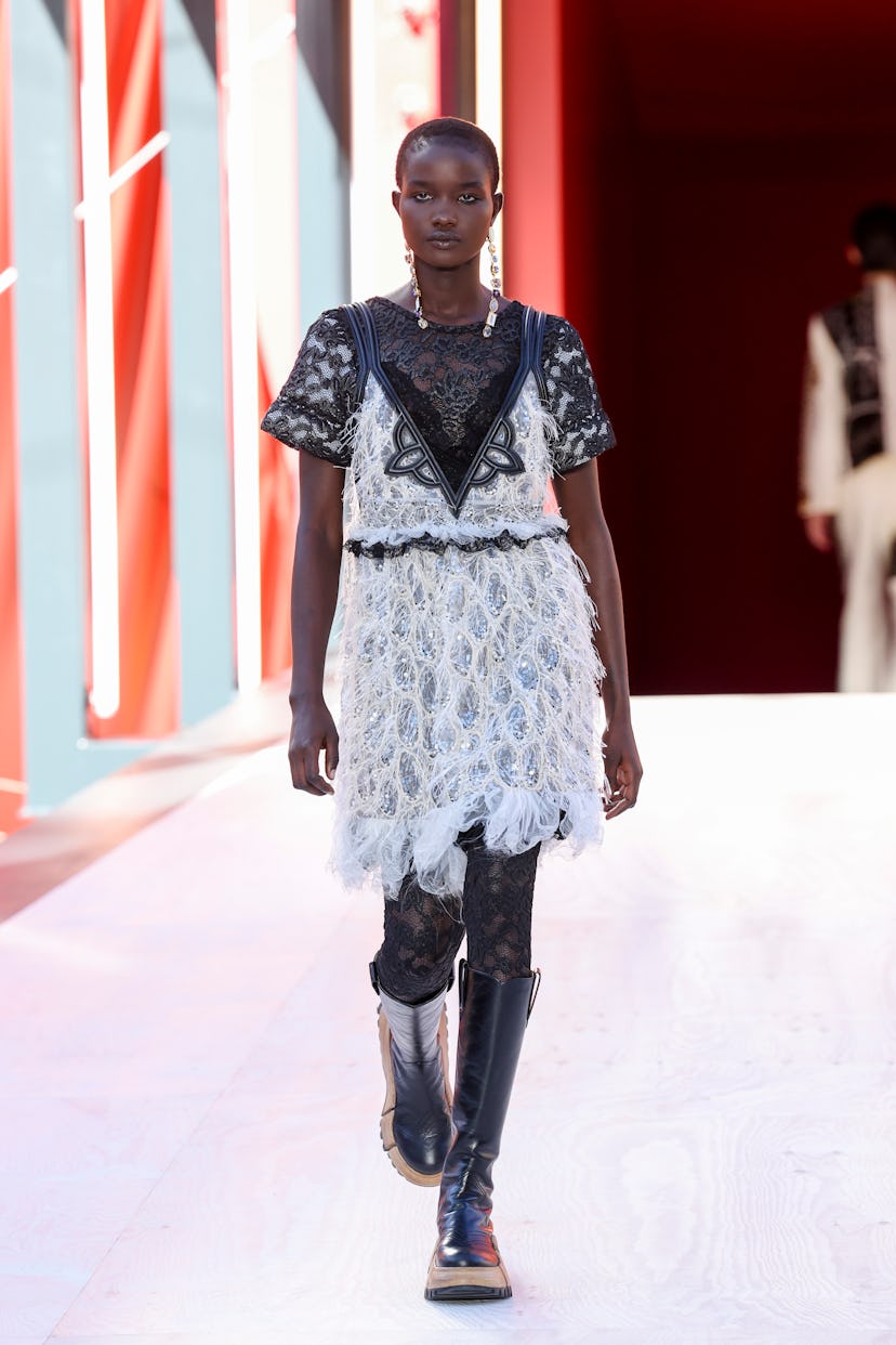 A model in a black-white lace dress at the Louis Vuitton Spring 2023 Paris Fashion Week