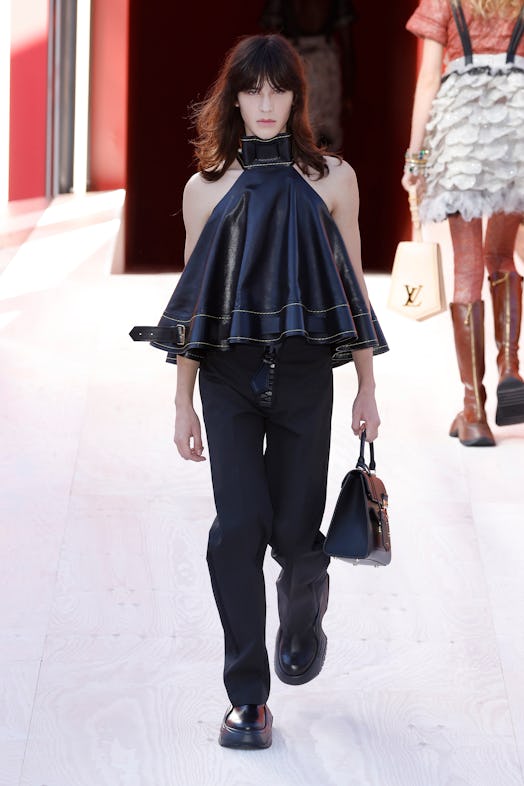 A model in a black leather top and denim trousers at the Louis Vuitton Spring 2023 Paris Fashion Wee...