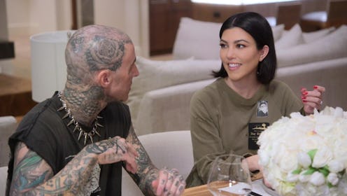 Kourtney Kardashian and Travis Barker having a meal together at a table