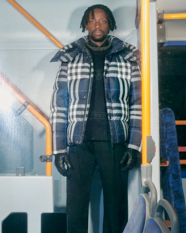 A model standing on a bus in a Burberry campaign
