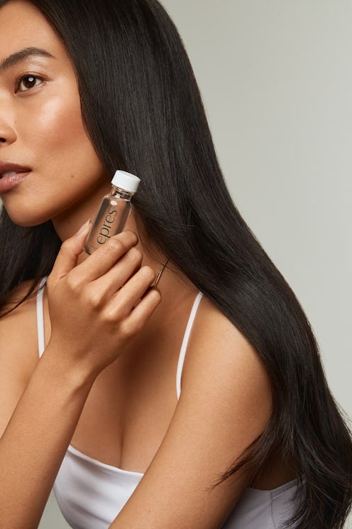 EPRES hair care model holding bottle