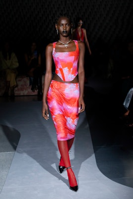 Model at Paris Fashion Week showing off brend Miaou in a bright orange, pink and blue combination