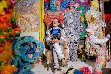 Raúl de Nieves in sitting on a chair in his bead-filled art studio