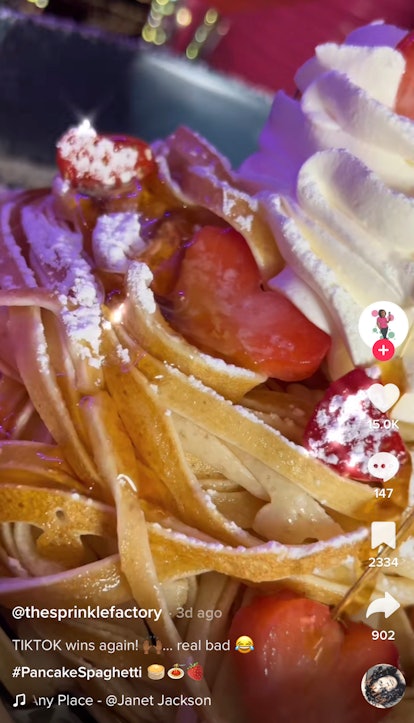 A TikToker shows how to make the pancake spaghetti TikTok recipe with strawberries. 