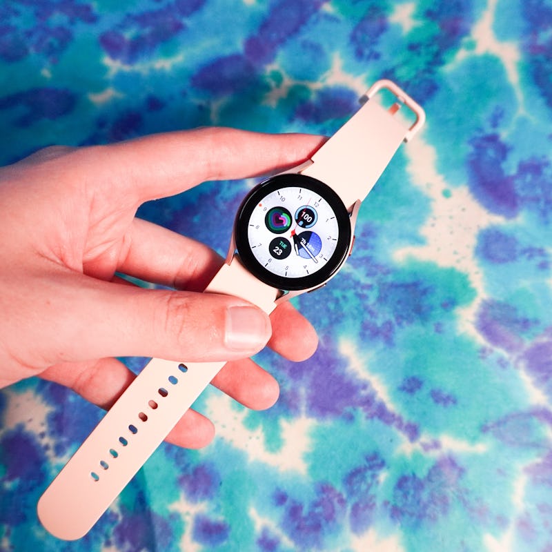 A person's hand holding the Samsung Galaxy Watch 5 smartwatch