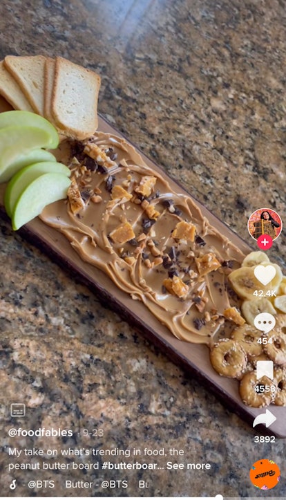 Peanut butter boards on TikTok include this version with chocolate chips and peanut brittle. 