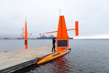 An employee checks on a Saildrone model before it's deployed on the ocean.