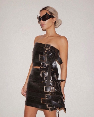 Kim Kardashian wearing a Balenciaga dress made of belts and large sunglasses