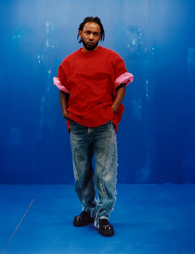 Kendrick Lamar wearing a Balenciaga red shirt, blue jeans and shoes