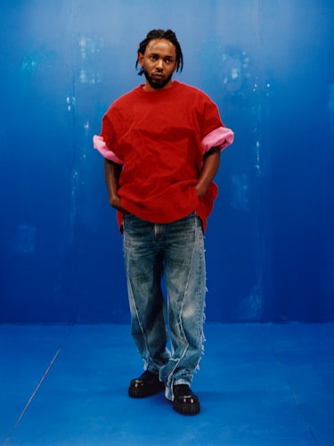 Kendrick Lamar wearing a Balenciaga red shirt, blue jeans and shoes