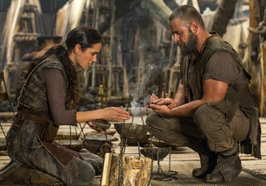 Russel Crowe and Jennifer Connelly kneeling above pots with steam coming out of them in Noah
