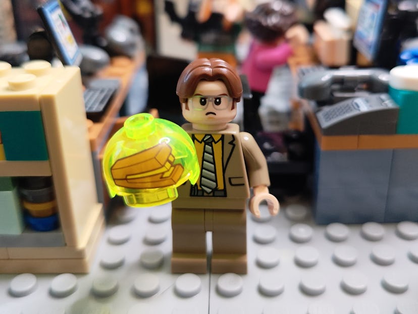 Dwight minifigure with an angry expression, holding a stapler trapped in a yellow jello mold. 