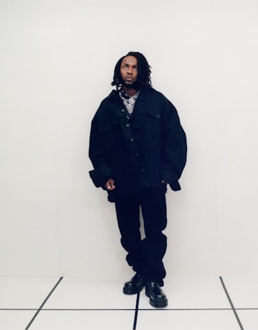 Kendrick Lamar wearing black Balenciaga jacket, jeans, and shoes; Tiffany & Co. ring; his own bandan...