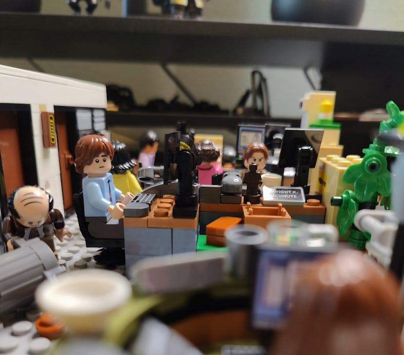 The Office Lego set with minifigures of the cast: Jim at a desk looking at Pam, Kevin picking up a c...
