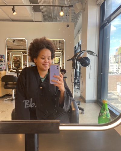 Natasha Marsh in a hair salon having her curl cut