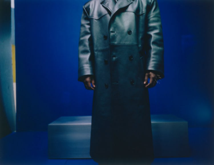 Kendrick Lamar wearing leather Prada coat, jumpsuit; Tiffany & Co. bracelets; his own bandanna.