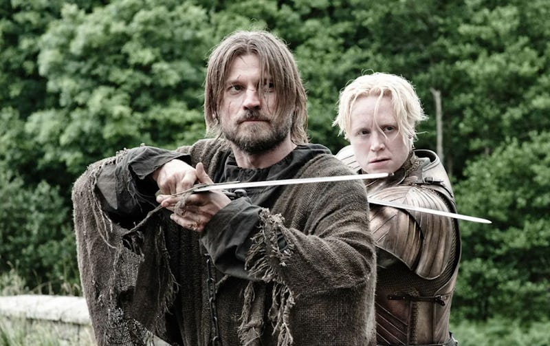 Jamie Lannister and Brienne of Tarth from Game of Thrones holding swords and pointing them straight