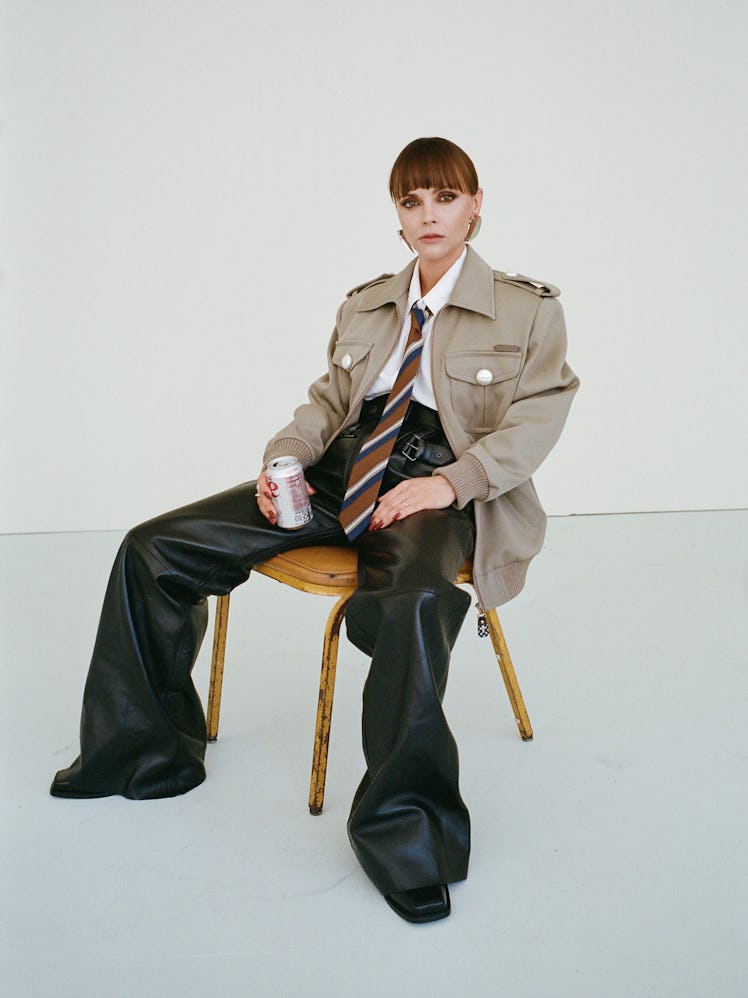 Christina Ricci wearing a beige Louis Vuitton jacket, shirt, leather pants, tie, and shoes; Saint La...