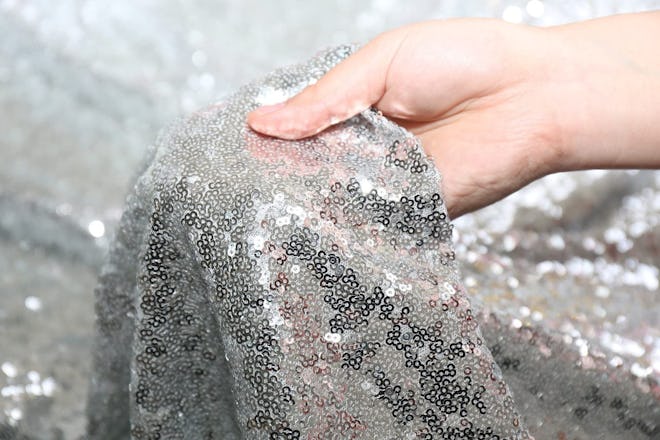 Amazon PartyDelight Silver Sequin Tablecloth 50"x50" for a glam holiday party decoration