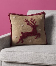 The deer motif pillow is part of Home Goods' 2022 Holiday collection available on Black Friday.