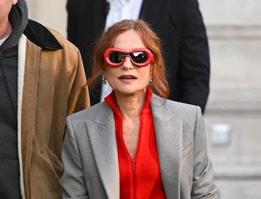 Isabelle Huppert wearing red Loewe sunglasses