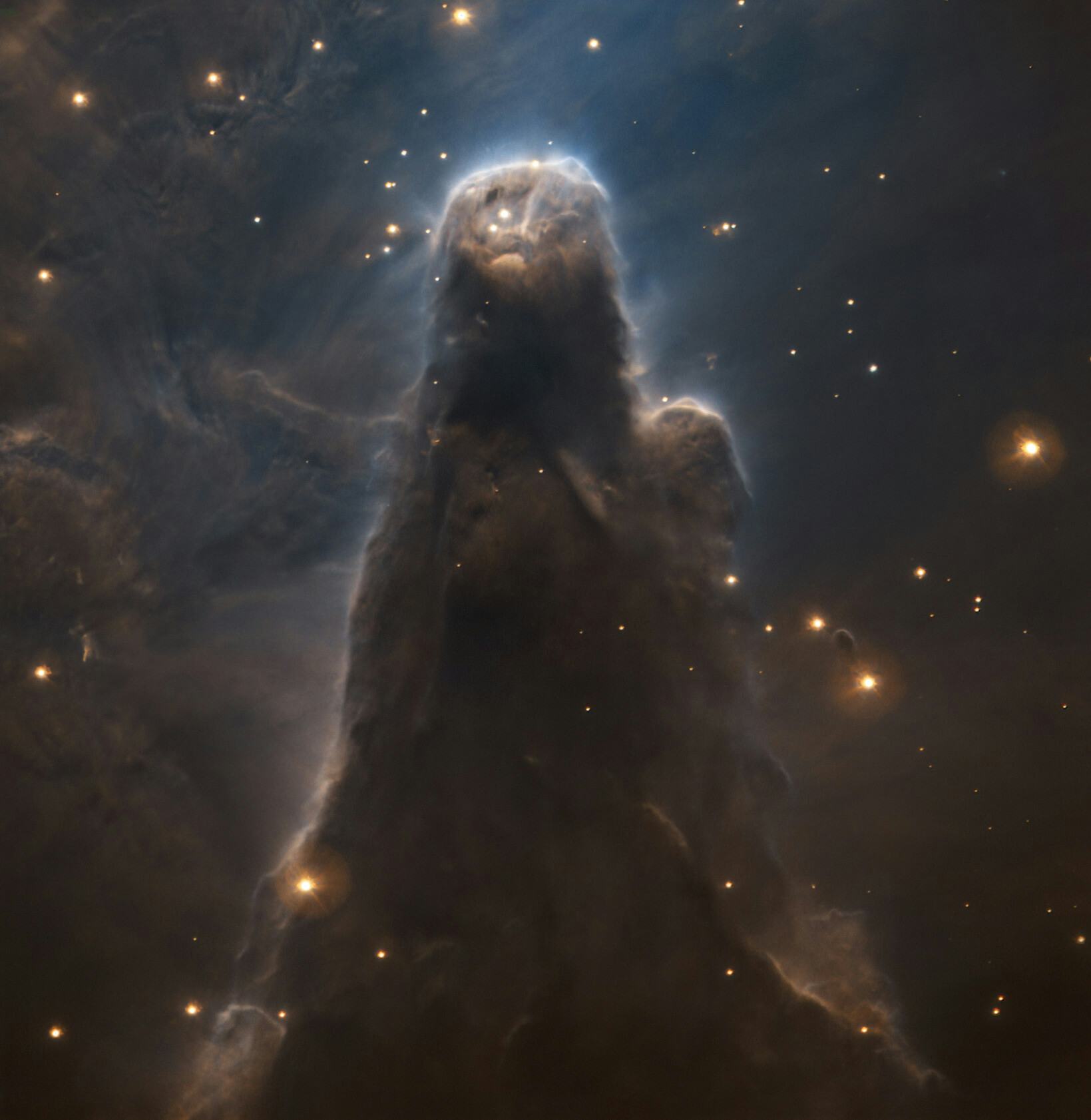 Dark pillar of dust rising in space with stars all around. Portrait of the cone nebula