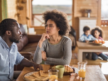 African American couple having serious conversation at breakfast table