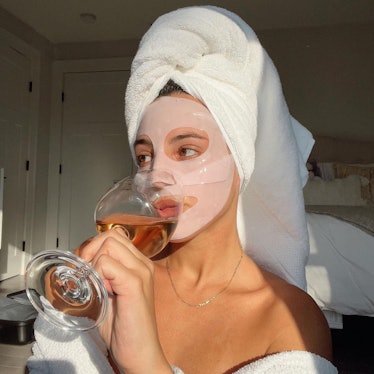 Revolve model in face mask and towel relaxing
