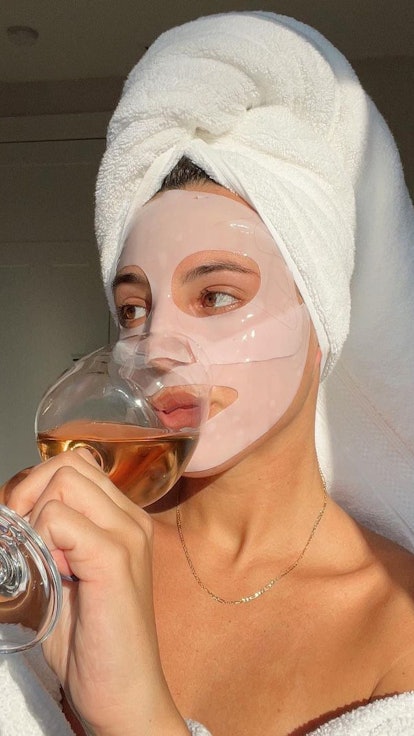 Revolve model in face mask and towel relaxing