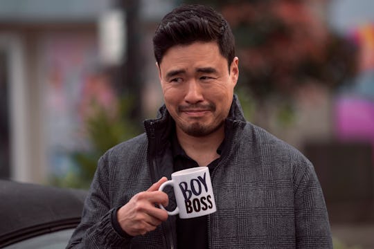 Randall Park as Timmy in episode 101 of 'Blockbuster' on Netflix.  He's holding a mug that says "BOY...