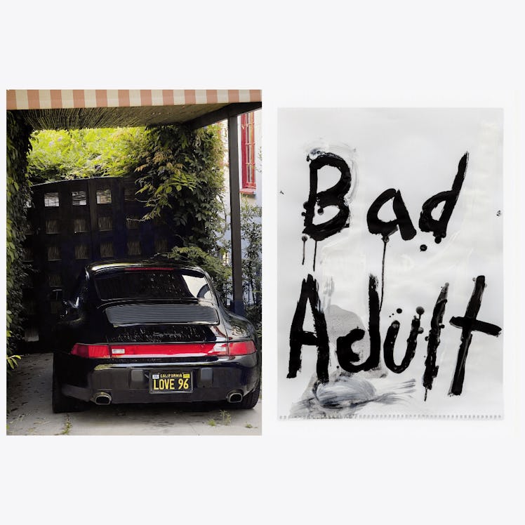 a photograph of a porsche with the words bad adult painted on a piece of paper next to it