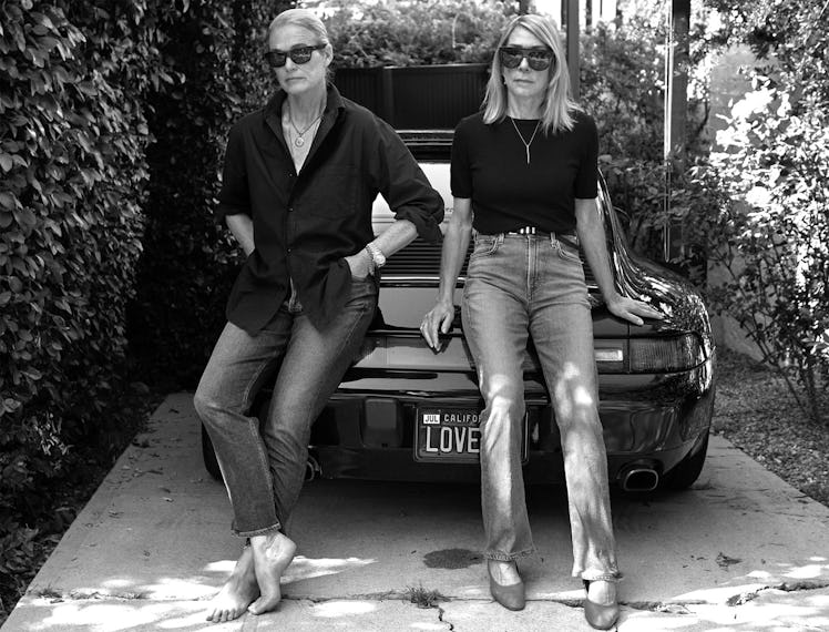 Kim Gordon and Lisa Love standing in front of a car 