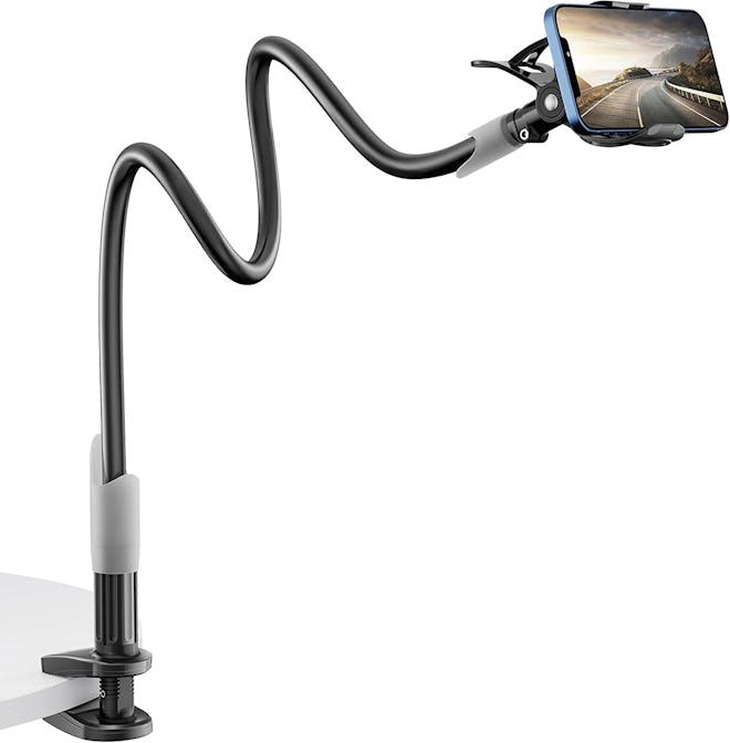 This phone stand can clamp onto a table and the flexible gooseneck can tilt, rotate, and swivel to r...