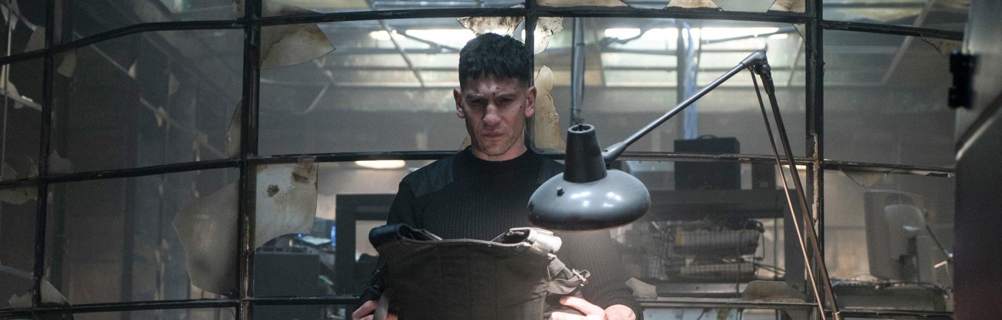 Frank Castle (Jon Bernthal) looks at a bulletproof vest in The Punisher Season 1