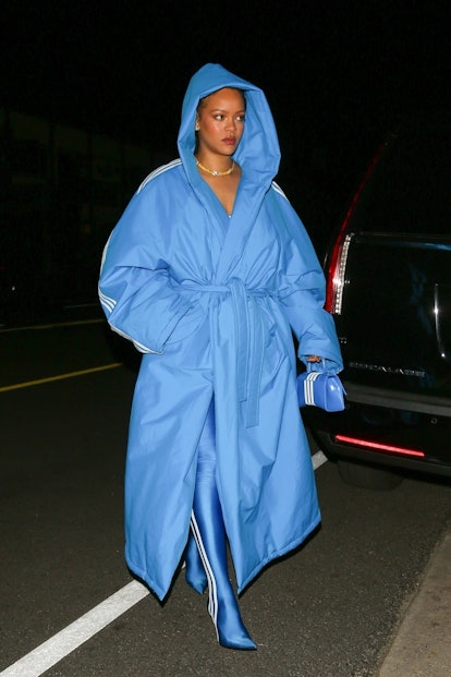 Rihanna in a blue long hooded coat