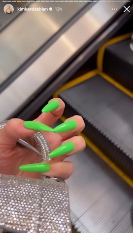Kim Kardashian wore neon green stiletto nails that were press ons for the SKKN By Kim holiday pop-up...