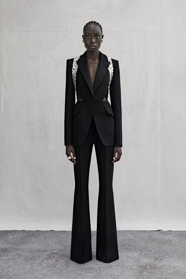 Alexander McQueen black suit with silver harness worn by a female model