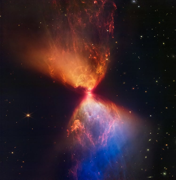 color photo of blue and orange molecular clouds in the shape of an hourglass in space