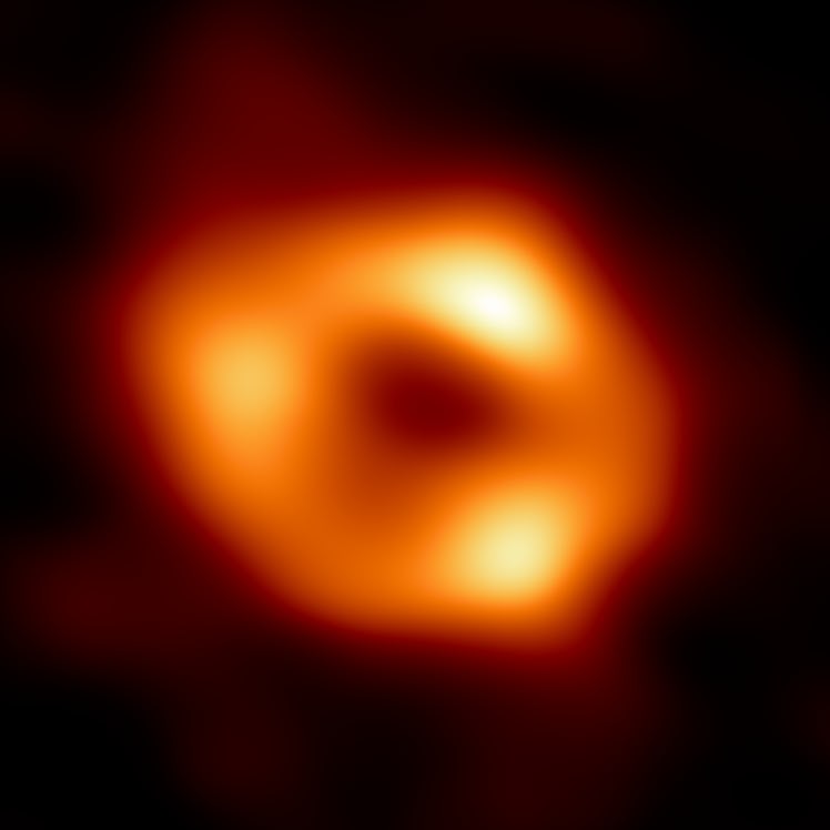 A bright orange circle with three clumps in it brighter than the fainter surrounding ring