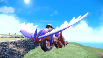 Koraidon gliding through the air with a trainer on its back